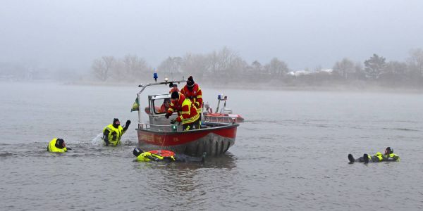 Feuerwehrleute in Überlebensanzügen in der Elbe. Foto: Matthias Köhlbrandt "Anbaden" in der eiskalten Elbe: Feuerwehr übt Menschenrettung