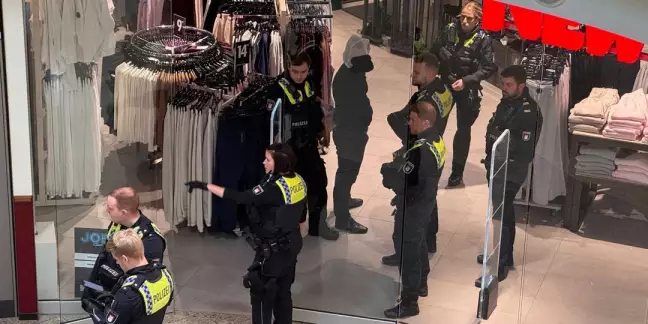 . In Handschellen mit Spuckschutzhaube wurde der vorläufig festgenommene Mann dann durch das Einkaufzentrum zum Auto und später zur Wache gebracht. Foto: Lenthe-Medien/Reimer